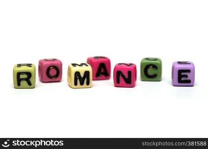 romance - word made from multicolored child toy cubes with letters