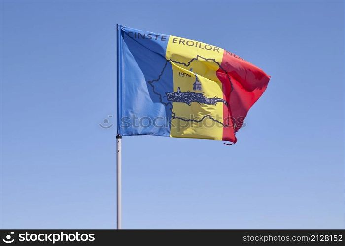 Romanian flag in the wind at Caraiman peak