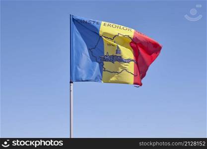 Romanian flag in the wind at Caraiman peak