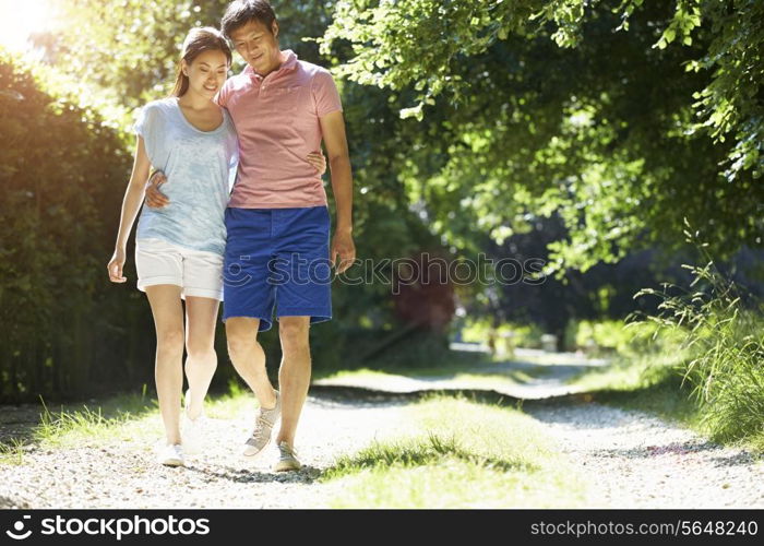 Romantic Asian Couple On Walk In Countryside