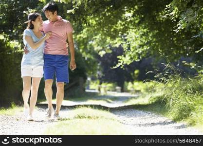Romantic Asian Couple On Walk In Countryside