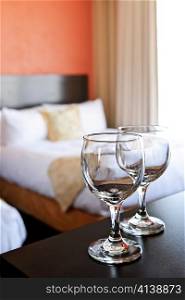 Romantic bedroom with wine glasses in luxury hotel interior