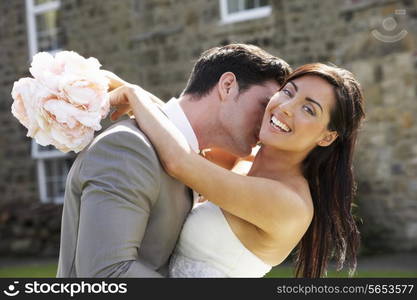 Romantic Bride And Groom Embracing Outdoors