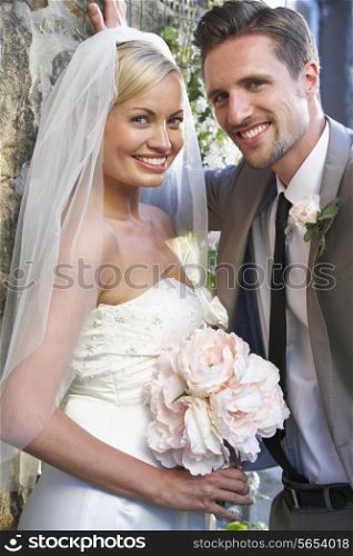 Romantic Bride And Groom Embracing Outdoors