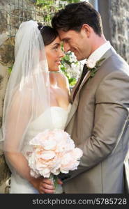 Romantic Bride And Groom Embracing Outdoors