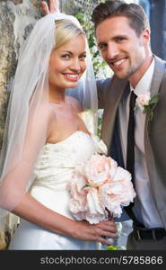 Romantic Bride And Groom Embracing Outdoors