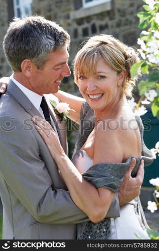 Romantic Bride And Groom Embracing Outdoors