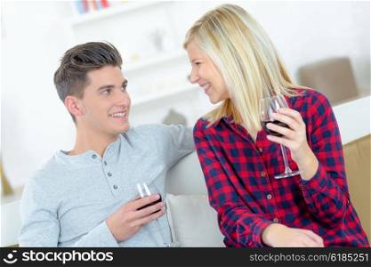 Romantic couple drinking wine on a sofa