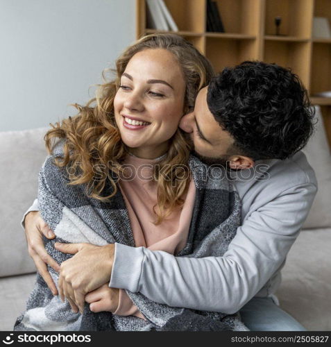 romantic couple embraced couch home