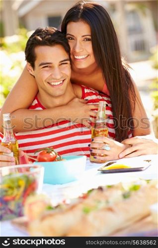 Romantic Couple Enjoying Outdoor Meal In Garden