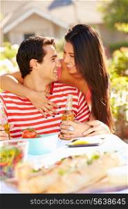 Romantic Couple Enjoying Outdoor Meal In Garden