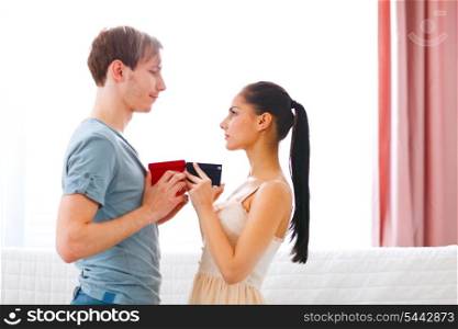 Romantic couple exchanging gifts&#xA;