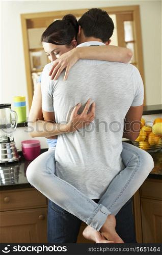 Romantic Couple Hugging In Kitchen