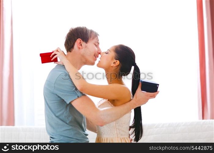 Romantic couple kissing after exchanging gifts&#xA;