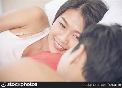 Romantic Couple lover look at other focus on beautiful woman on bed. woman smiling to boyfriend. Lover Concept.