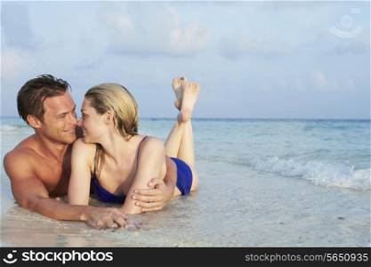 Romantic Couple Lying In Sea On Tropical Beach Holiday