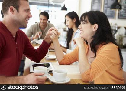 Romantic Couple Meeting In Busy Cafe