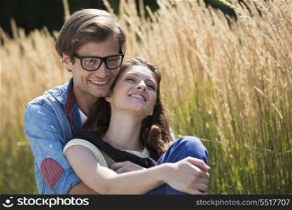 Romantic couple relaxing in field
