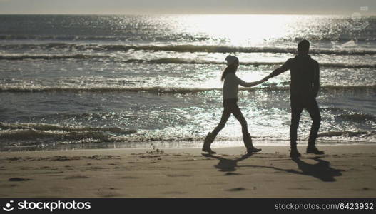 Romantic Couple Relaxing On The Beach during autumn day