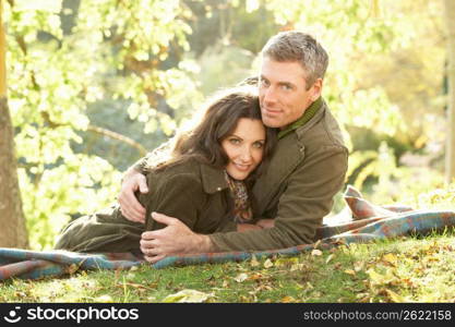 Romantic Couple Relaxing Outdoors In Autumn Landscape