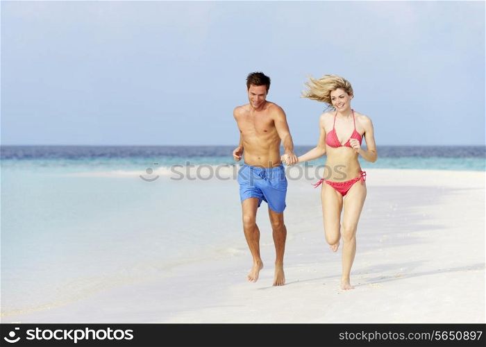 Romantic Couple Running On Beautiful Tropical Beach