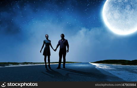 Romantic couple. Silhouettes of young romantic couple standing under the moon light