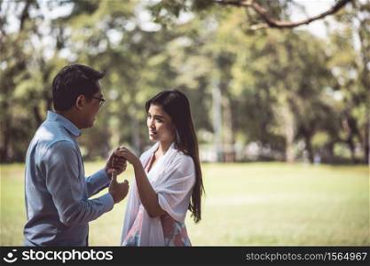 Romantic Couple Standing On Field At Park