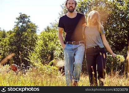 Romantic couple strolling in rural field