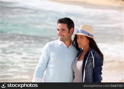Romantic couple walking by the beach