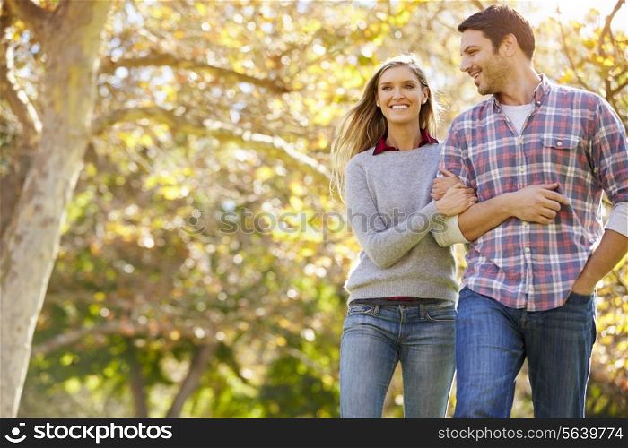 Romantic Couple Walking Through Autumn Woodland