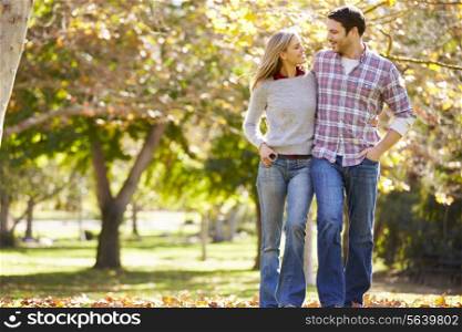Romantic Couple Walking Through Autumn Woodland
