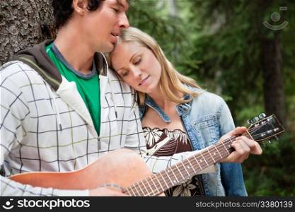 Romantic couple with man playing the guitar