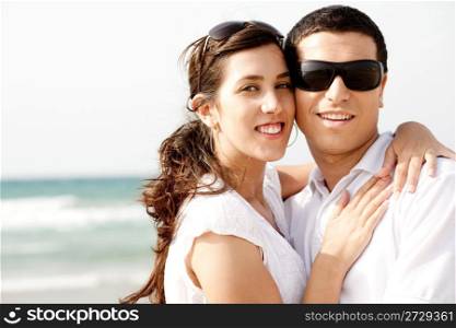 Romantic coupleholding and smiling eachother while at the beach,outdoor