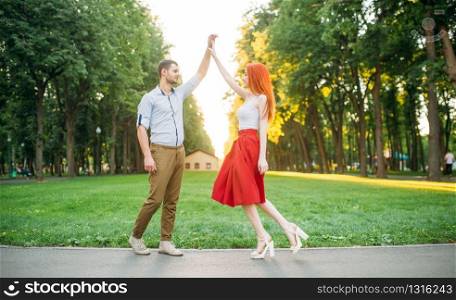 Romantic date, love couple happiness together, meeting in summer park. Attractive woman and young man leisure outdoors
