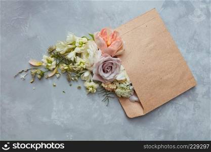 Romantic envelope with flowers on the stone gray background. flat lay. Romantic envelope with flowers