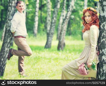 Romantic gentle bride and handsome groom posing near birch trees, beautiful young loving couple, summer time, happy wedding day concept