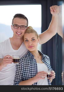 romantic happy young couple enjoying morning coffee by the window in their luxury home