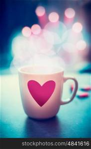 Romantic lifestyle with mug and heart at bokeh background, front view. Love symbol or Valentines day concept
