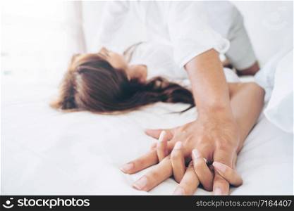 Romantic love of intimate young couple in home bedroom foreplay in the bed.. Romantic love of young couple in the bedroom.