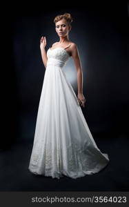 Romantic lovely bride fashion model demonstrates white bridal dress on podium. Series of photos