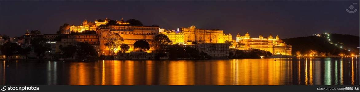 Romantic luxury India travel tourism - City Palace complex on Lake Pichola in twilight, Udaipur, Rajasthan, India