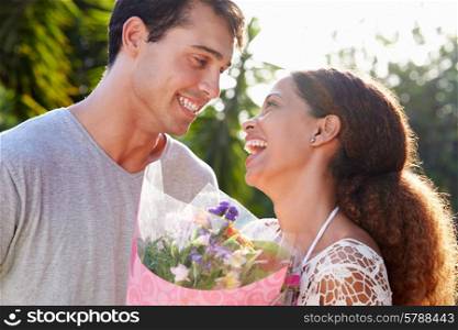 Romantic Man Giving Woman Bunch Of Flowers