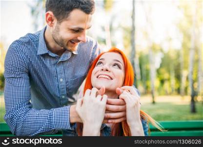 Romantic meeting of love couple in summer park. Man and woman hugs outdoors. Romantic meeting of love couple in summer park