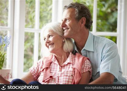 Romantic Middle Aged Couple Looking Out Of Window