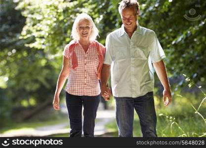 Romantic Middle Aged Couple Walking Along Countryside Path