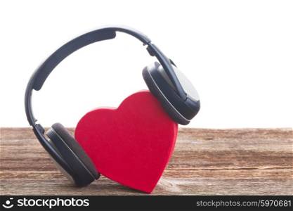 Romantic music concept - red heart with headphones, border on white