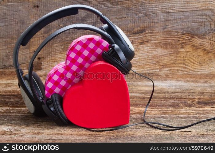 Romantic music concept . Romantic music concept - two pink and red hearts with headphones