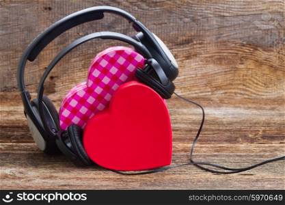 Romantic music concept . Romantic music concept - two pink and red hearts with headphones
