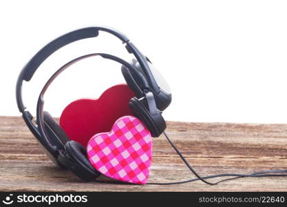 Romantic music concept - two red and pink hearts with headphones, border on white