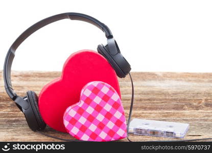 Romantic music concept - two red and pink hearts with headphones, border over white